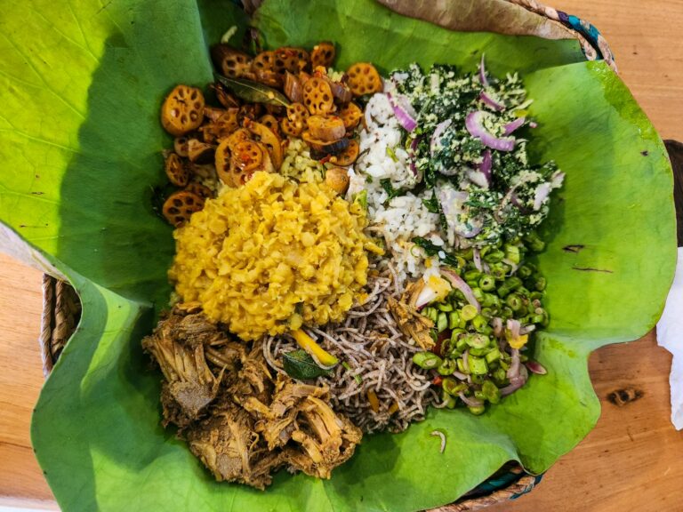 A home-cooked meal served on a banana leaf