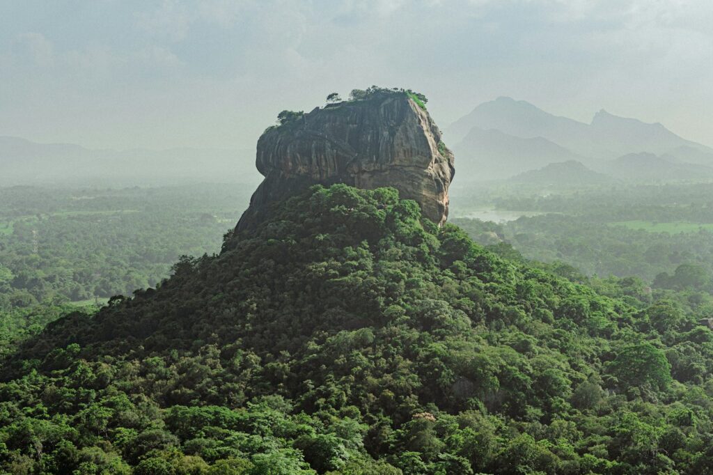 Sigiriya Rock rising above green forest
